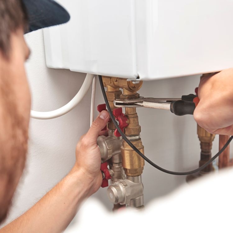 man fixing boiler