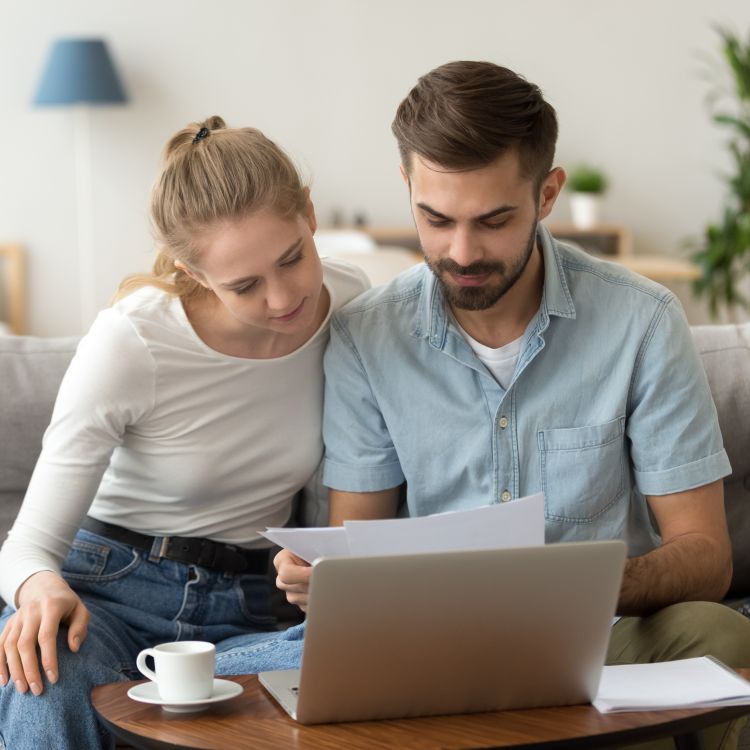 Young couple holding reading rent documents - Platform Rent Review 2025