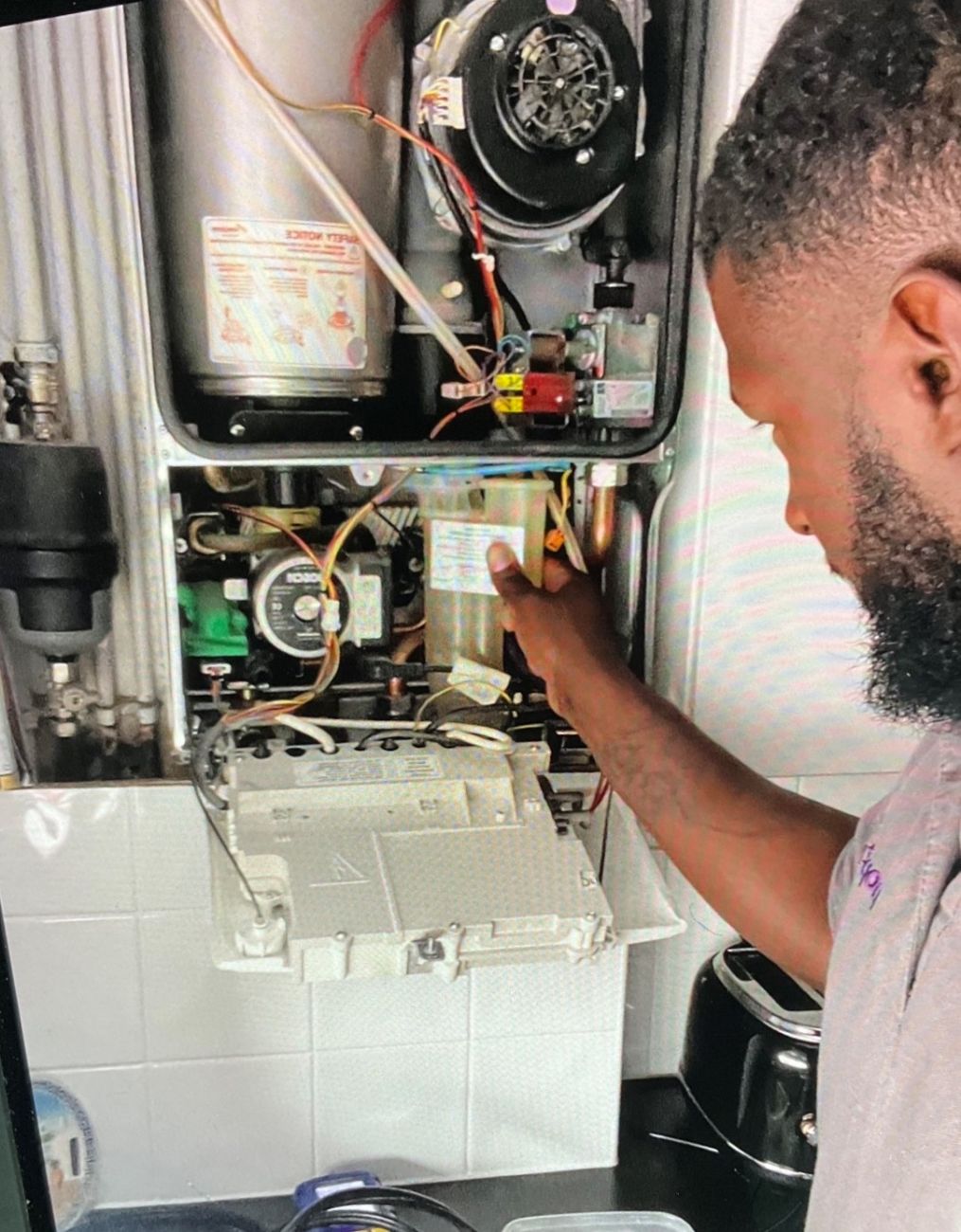 Gas engineer doing a service check on a boiler