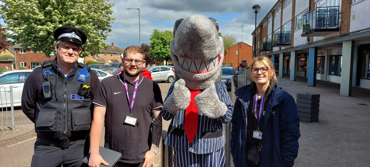 Police officer and Platform Colleagues are pictured with Syd the Shark out and about in the community